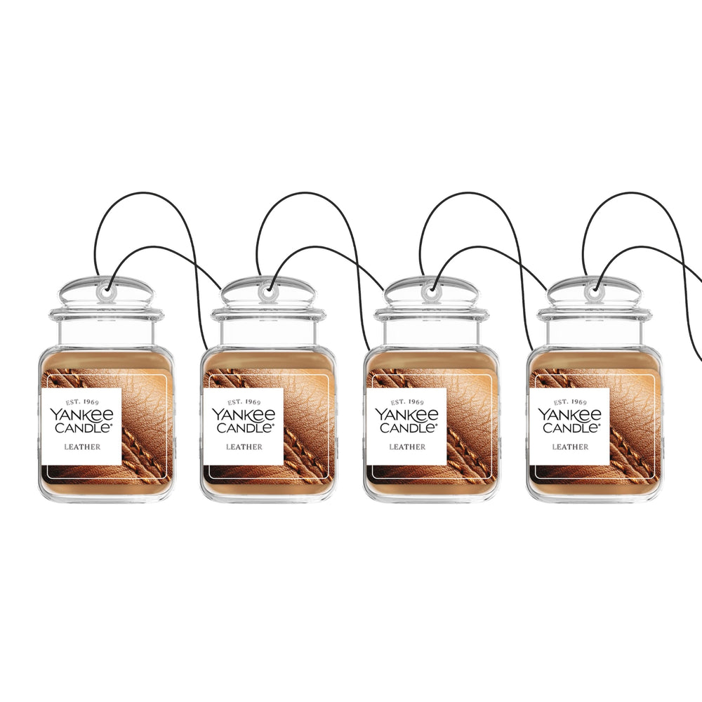 Yankee Candle Car Jar Ultimate Leather bottle releasing a true-to-life fragrance in a car interior