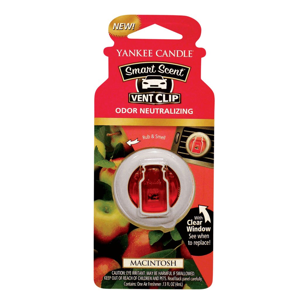 Yankee Candle Macintosh vent clips attached to a car vent for adjustable scent control.