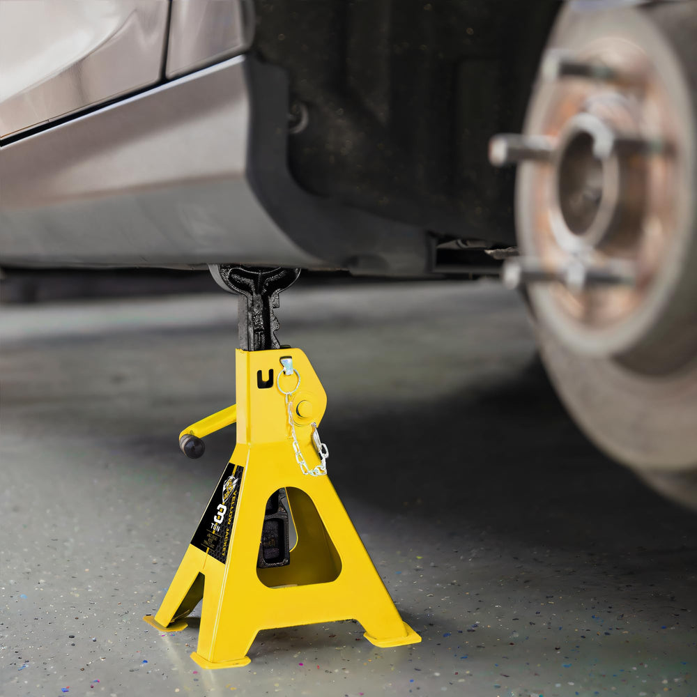 Yellow Jacket stands set up in a garage for vehicle maintenance.