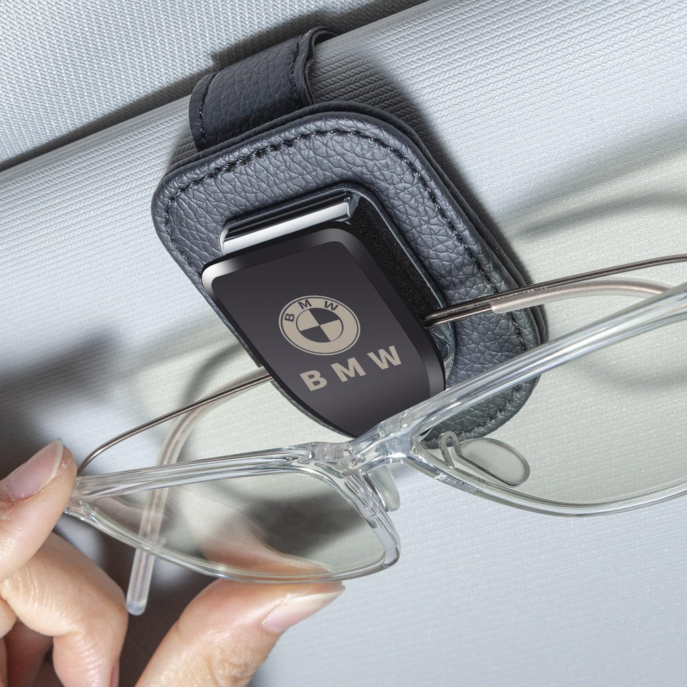 YUIQIEUY sunglasses holder on BMW visor secures glasses for easy access.