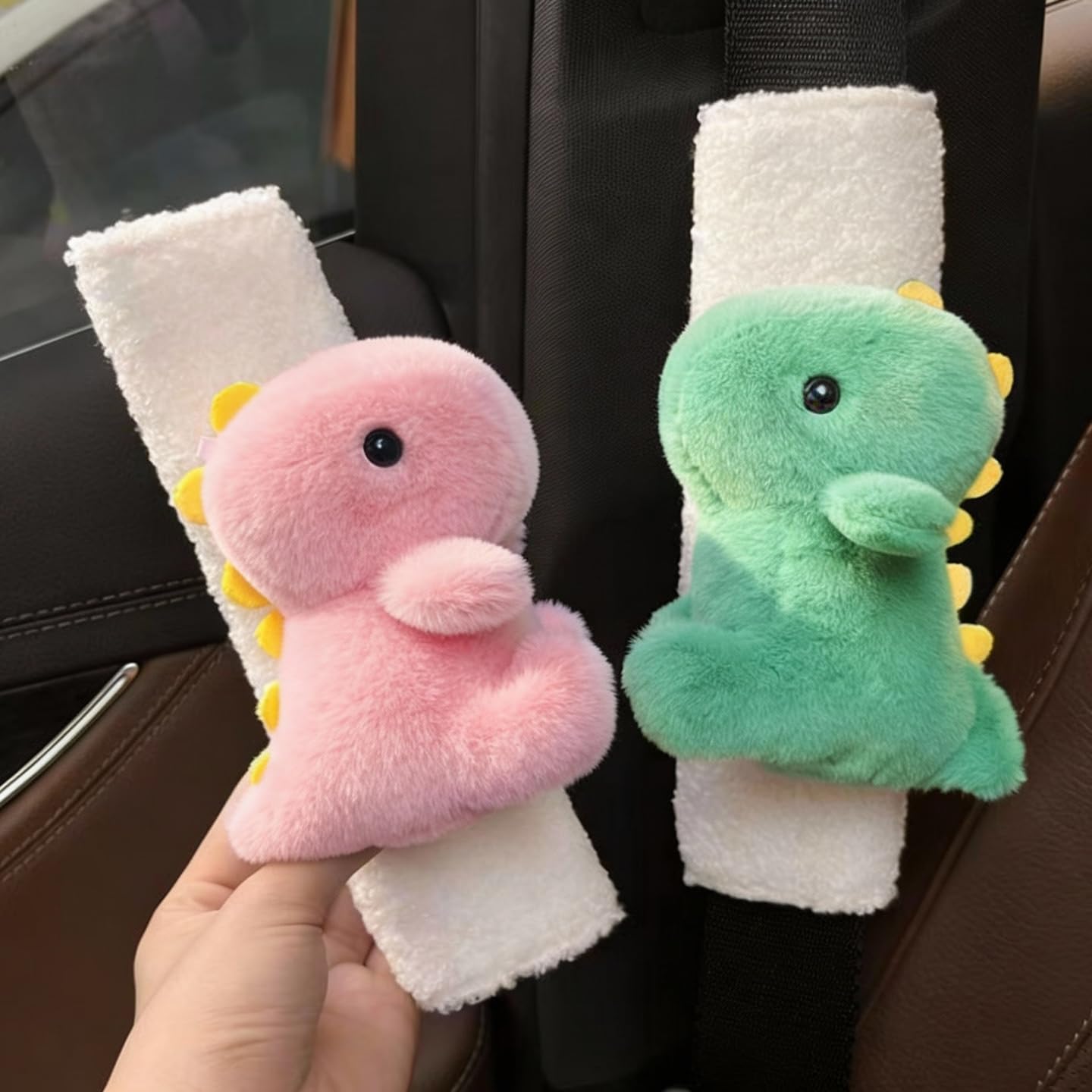 Zigihos pink dinosaur seatbelt pad reduces friction for kid car rides.